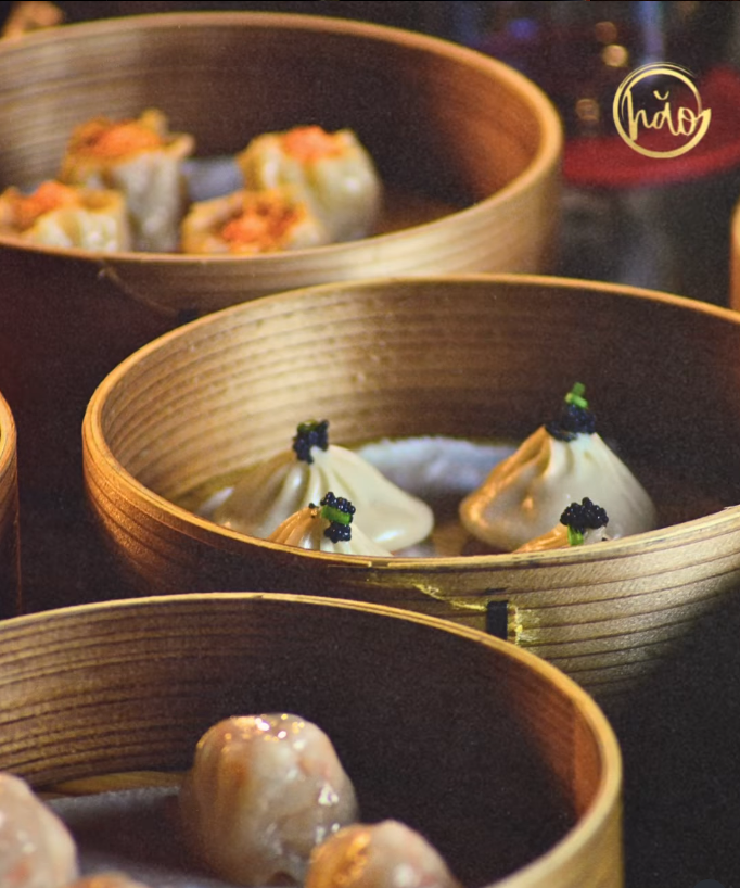 Delicate dumplings with caviar toppings in bamboo steamers