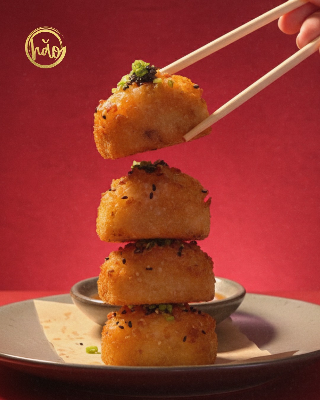 Golden ham sui gok stacked with chopsticks against red background