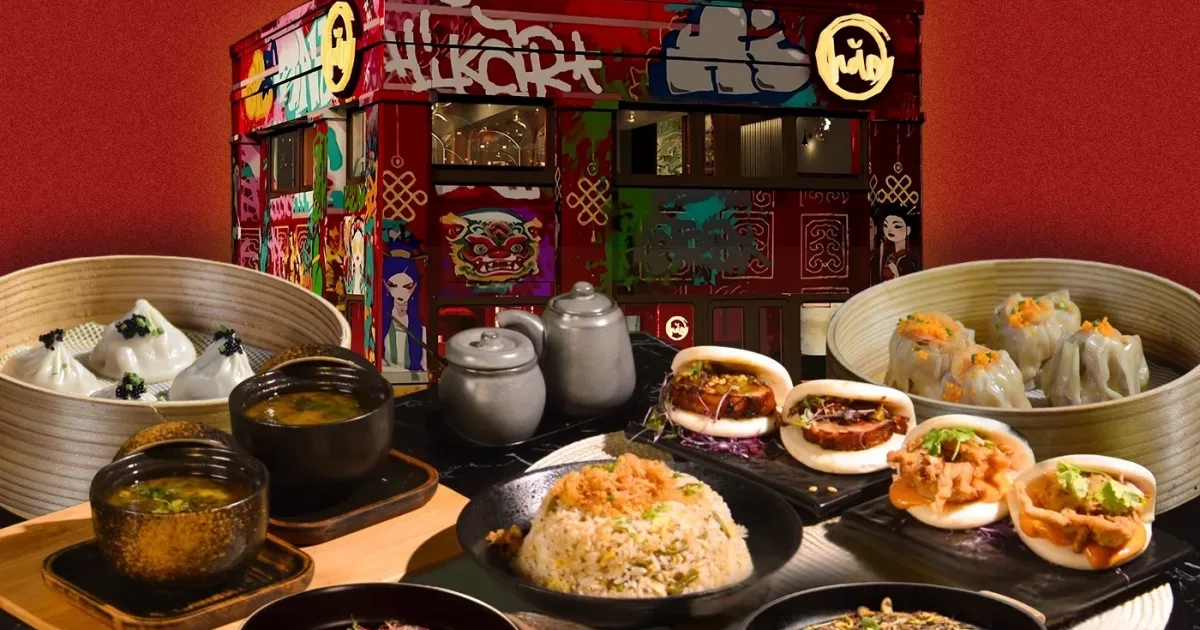 hăo modern dim sum spread with dumplings, bao, and fried rice against the colorful exterior facade