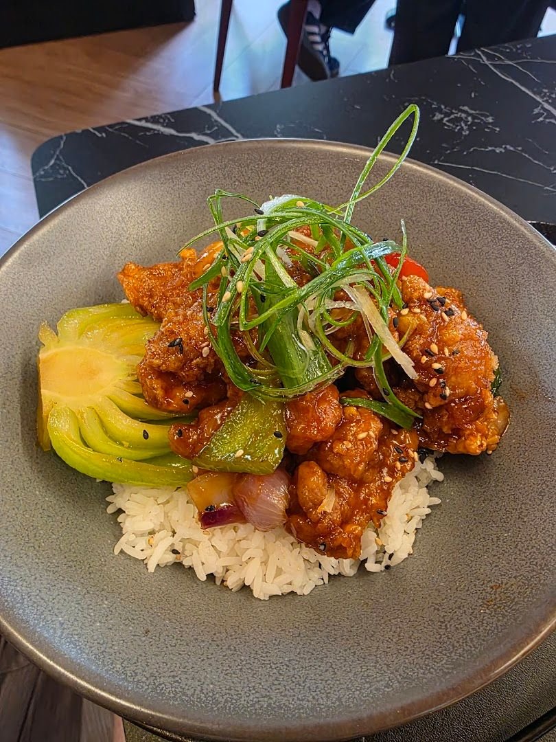 Rice bowl with crispy chicken, bok choy, and scallions